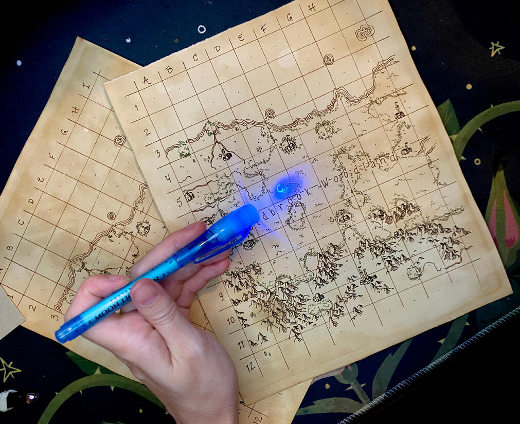 An example of a hidden letter on the map being revealed by black light