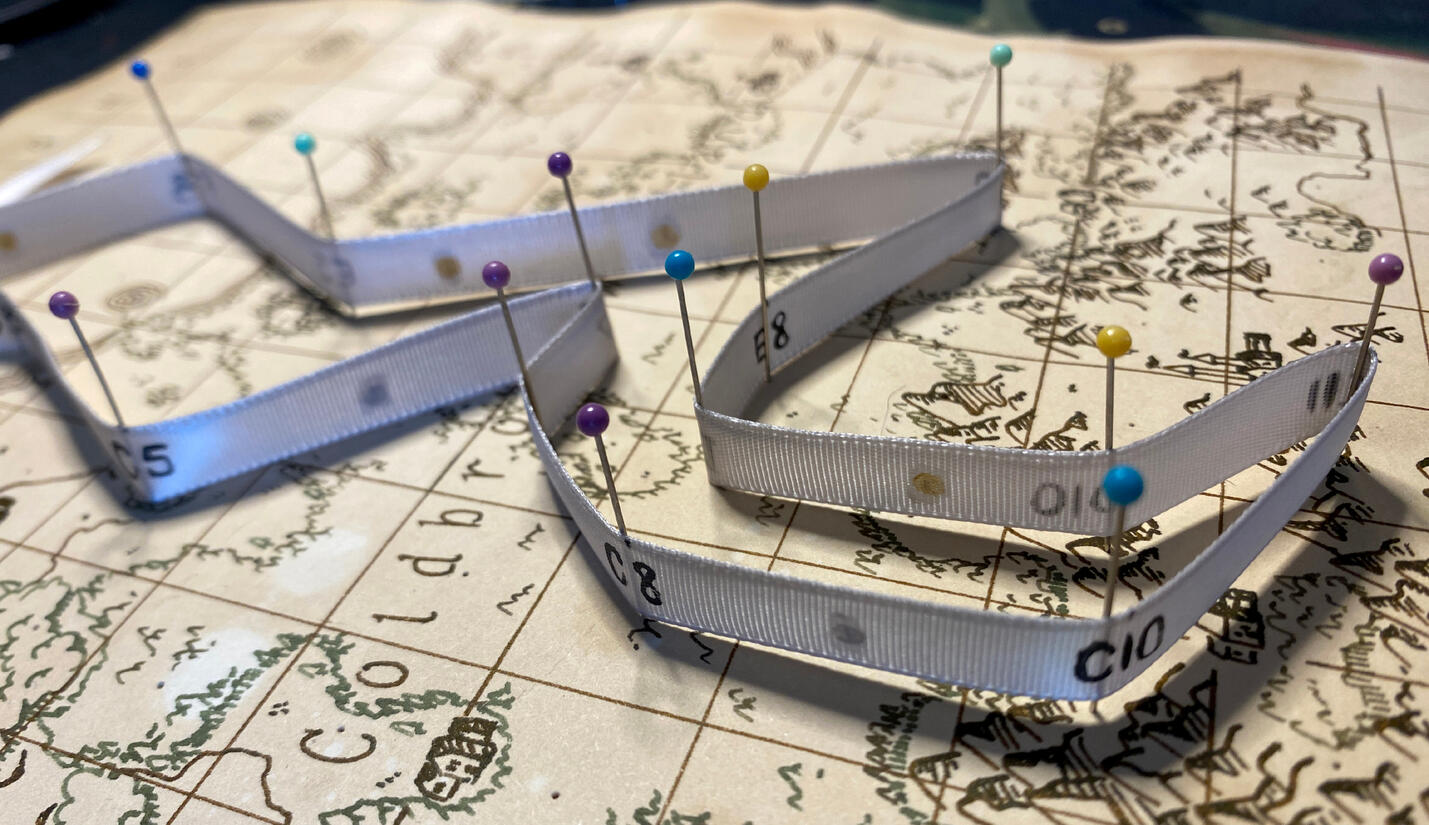 A close-up of the pinned ribbon that shows the coordinates written on the ribbon.